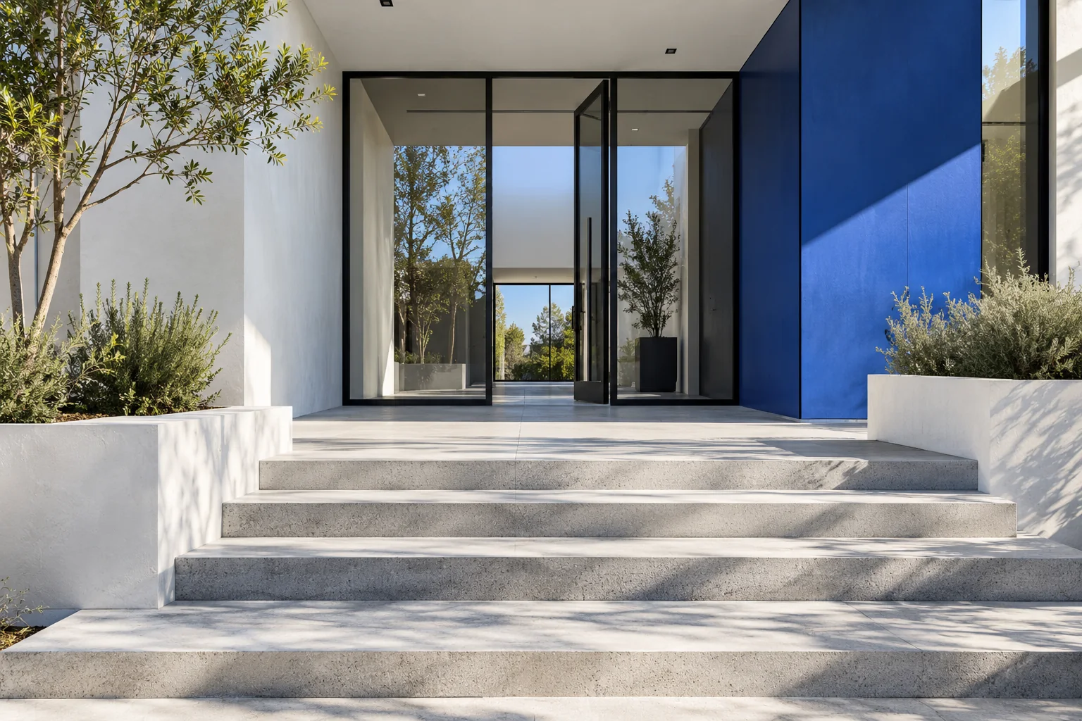 A precise white architectural entrance with cobalt accents and strong natural light