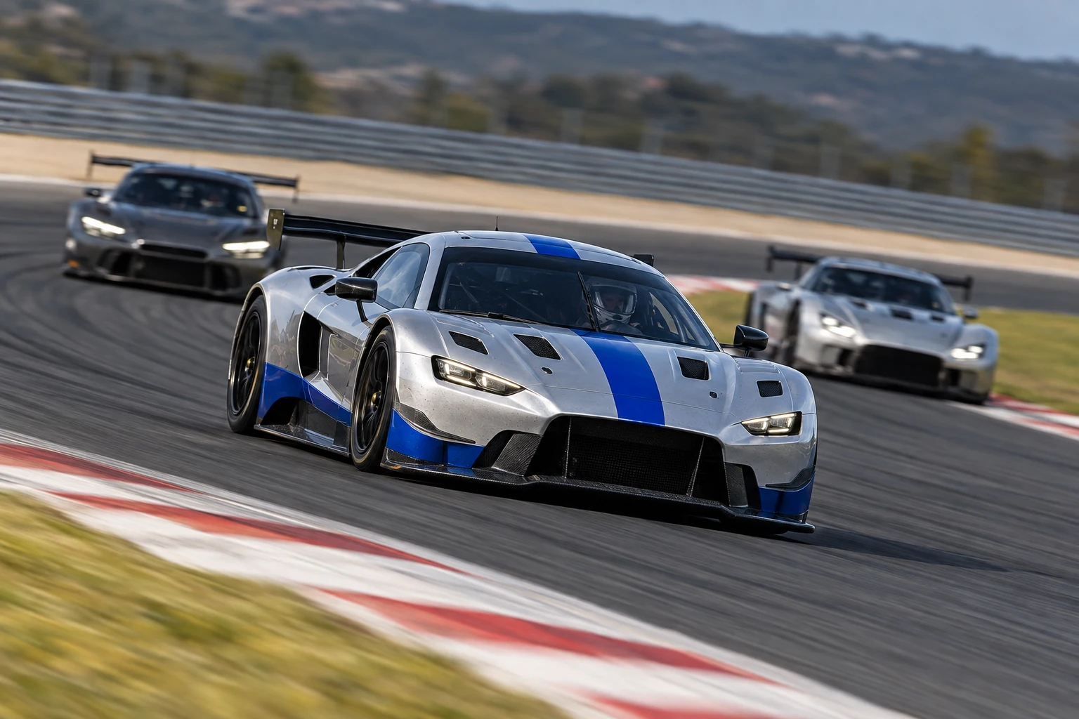 A silver and cobalt race car pulling ahead of the field on a racing circuit